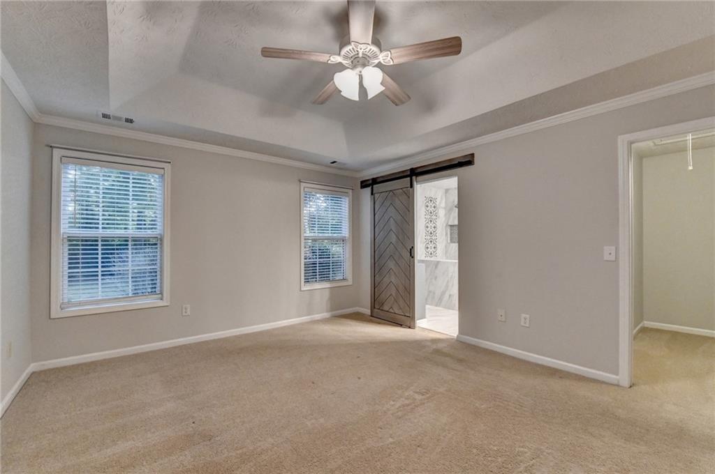 310 Andrew Ridge Drive Jefferson, GA 30549 - Photo 31 of 52 an empty room with chandelier fan and windows