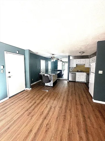 a living room with a couch and wooden floor