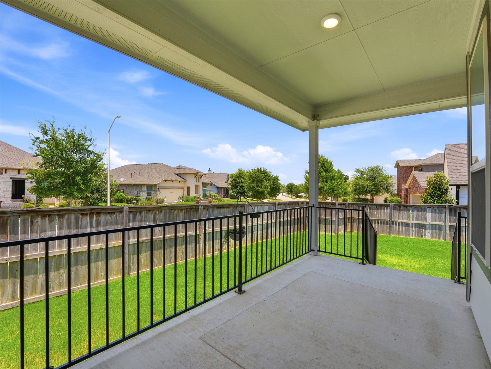 2132 Ringstaff Road Leander, TX 78641 - Photo 37 of 39 Enjoy outdoor living and scenic views from this charming covered patio and fenced backyard.
