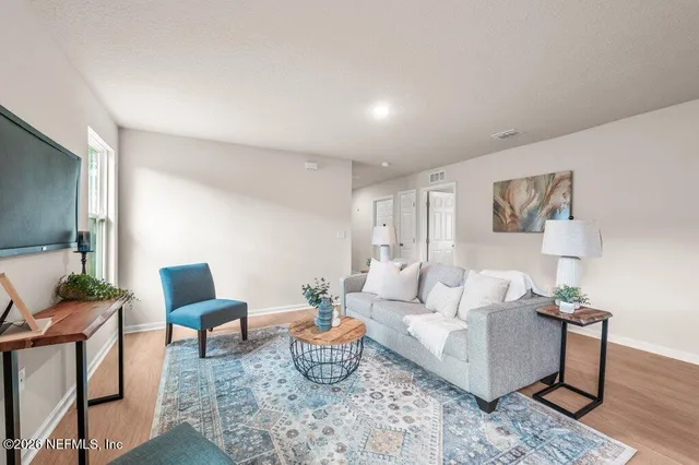 a living room with furniture and a potted plant