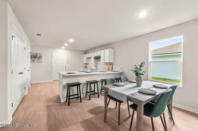 a view of a dining room with furniture and wooden floor