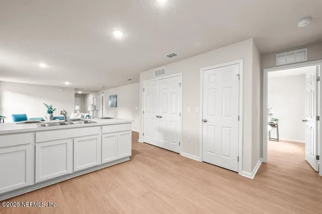 a spacious bathroom with double vanity and a mirror