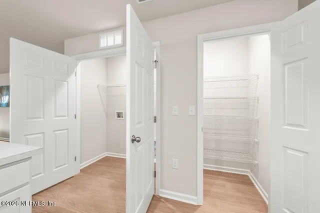 a view of a bathroom with white door