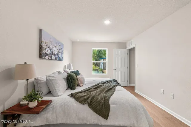 a bedroom with a bed and window