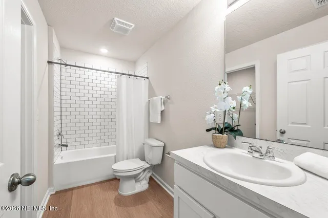 a bathroom with a sink toilet tub and shower
