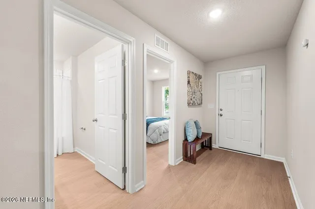 a view of a livingroom with furniture and a hallway