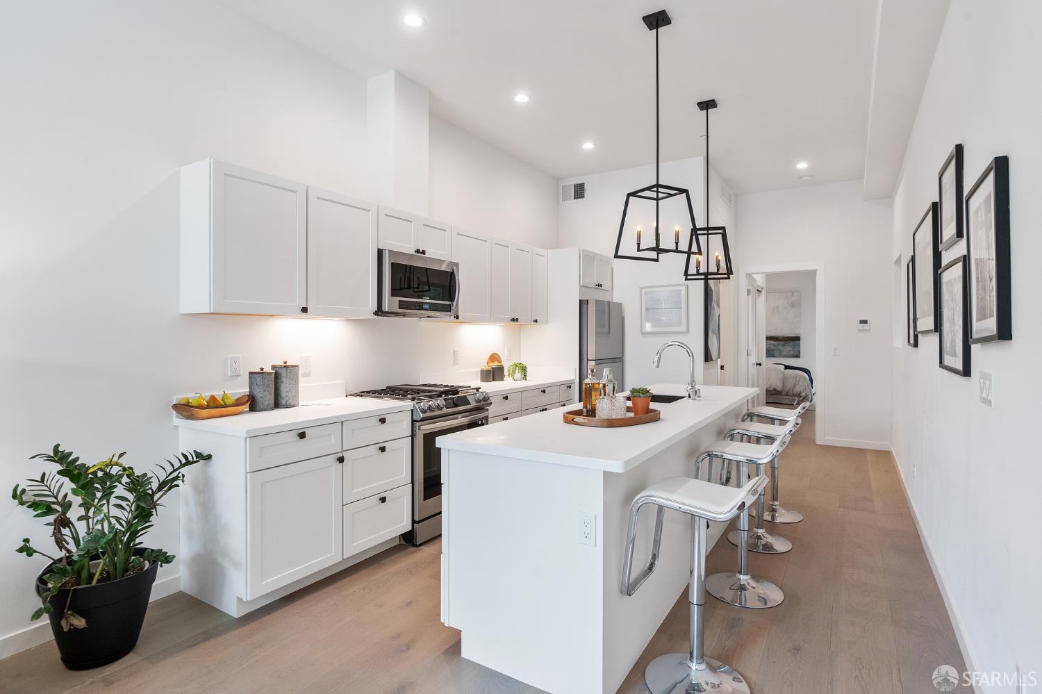 3036 Fulton Street, Unit 1 San Francisco, CA 94118 - Photo 3 of 13 a kitchen with a sink a stove and chairs