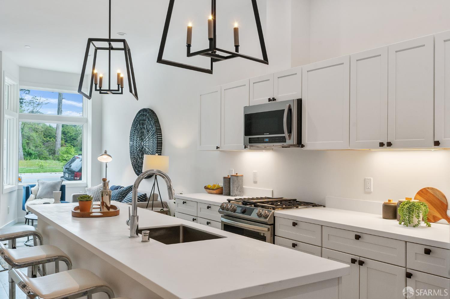 3036 Fulton Street, Unit 1 San Francisco, CA 94118 - Photo 6 of 13 a kitchen with stainless steel appliances a sink a stove a microwave a sink and cabinets