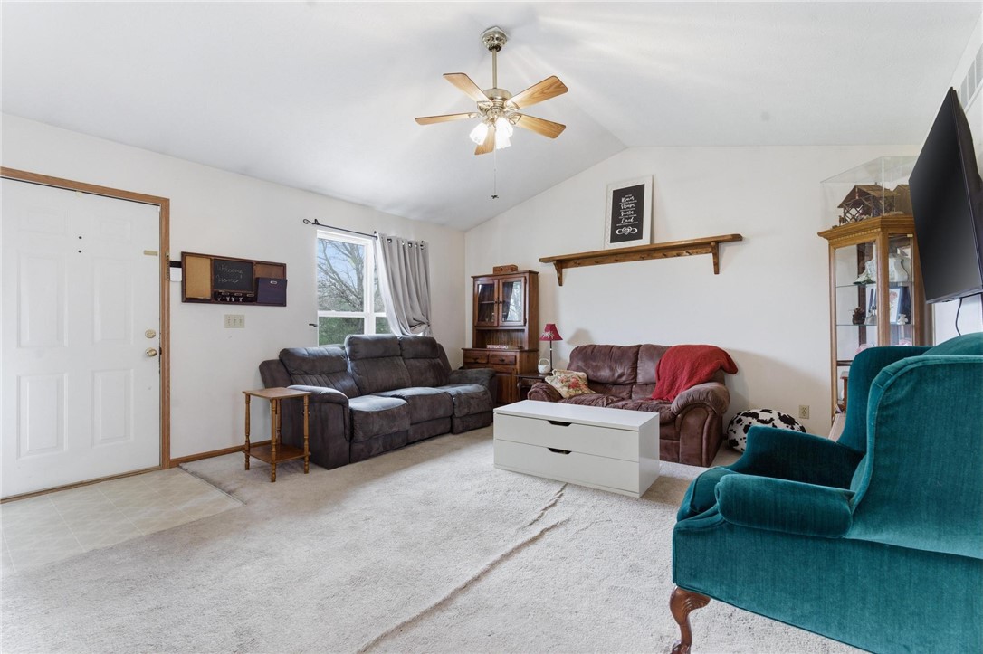 8747 Waynes Way Blanchester, OH 45107 - Photo 5 of 40 This inviting living area features vaulted ceilings and carpeted flooring, perfect for comfortable gatherings.