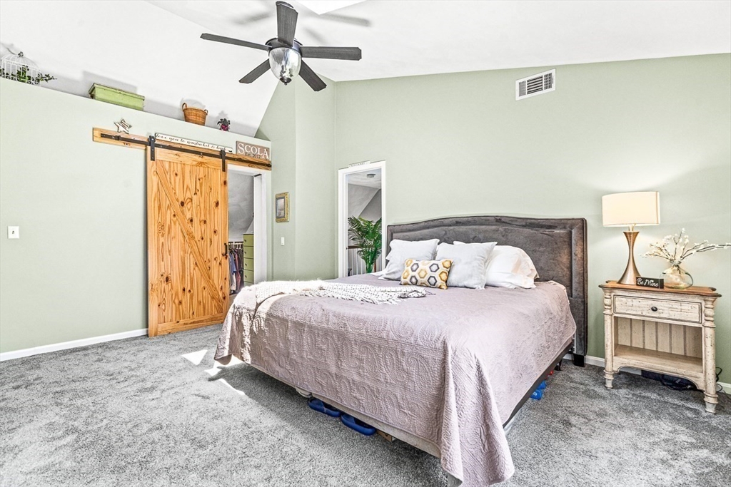 27 A Andrews Farm Road Boxford, MA 01921 - Photo 18 of 37 a bedroom with a bed and a chandelier