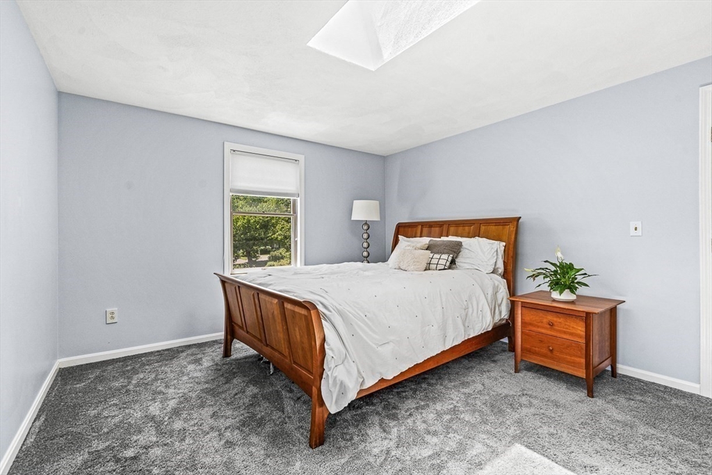27 A Andrews Farm Road Boxford, MA 01921 - Photo 23 of 37 a bed sitting in a bedroom next to a window