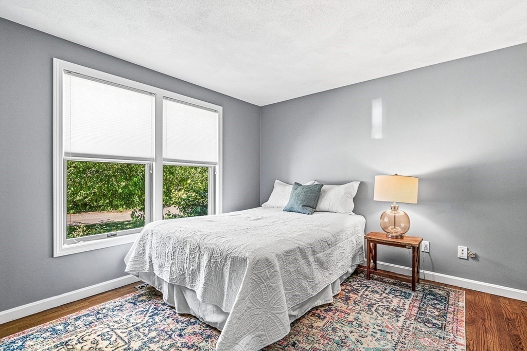 27 A Andrews Farm Road Boxford, MA 01921 - Photo 25 of 37 a bedroom with a bed and wooden floor
