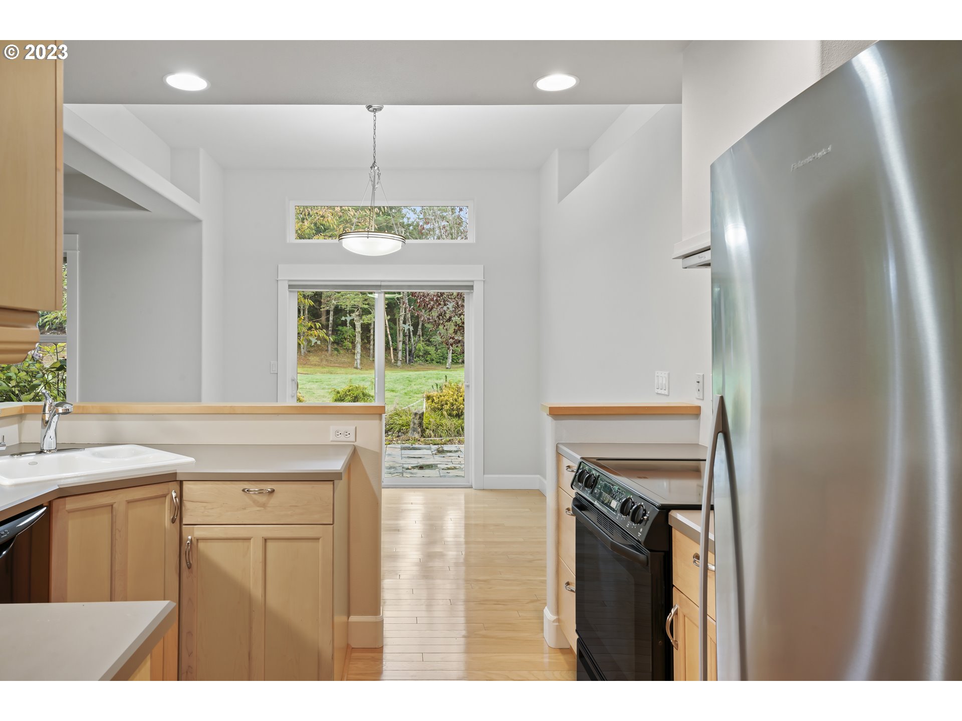 4 Waterford Downs Florence, OR 97439 - Photo 17 of 41 a kitchen with kitchen island a counter top space a sink a refrigerator and a stove