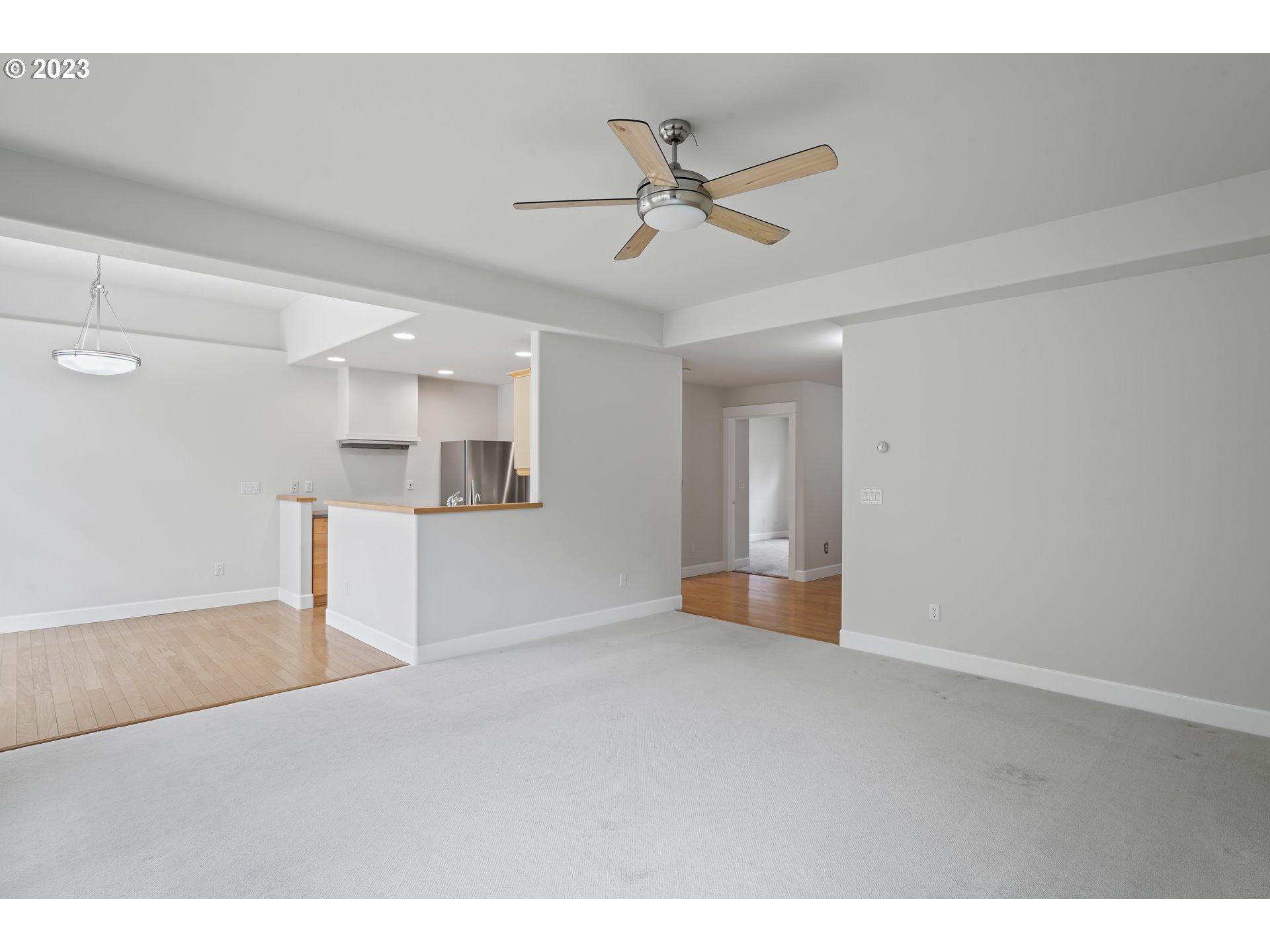 4 Waterford Downs Florence, OR 97439 - Photo 9 of 41 a view of an empty room with wooden floor and a ceiling fan