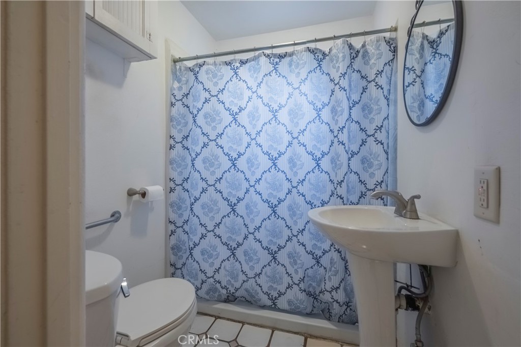 10180 Eddystone Street Riverside, CA 92503 - Photo 16 of 34 a bathroom with a sink toilet and a mirror
