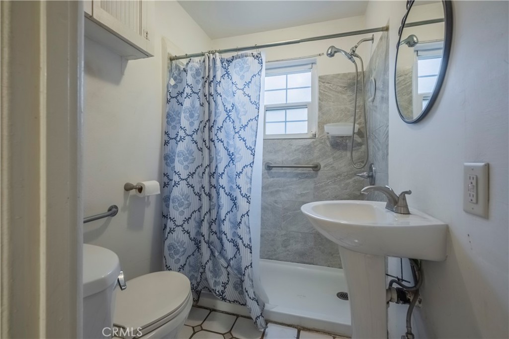 10180 Eddystone Street Riverside, CA 92503 - Photo 17 of 34 a bathroom with a sink a toilet and a mirror