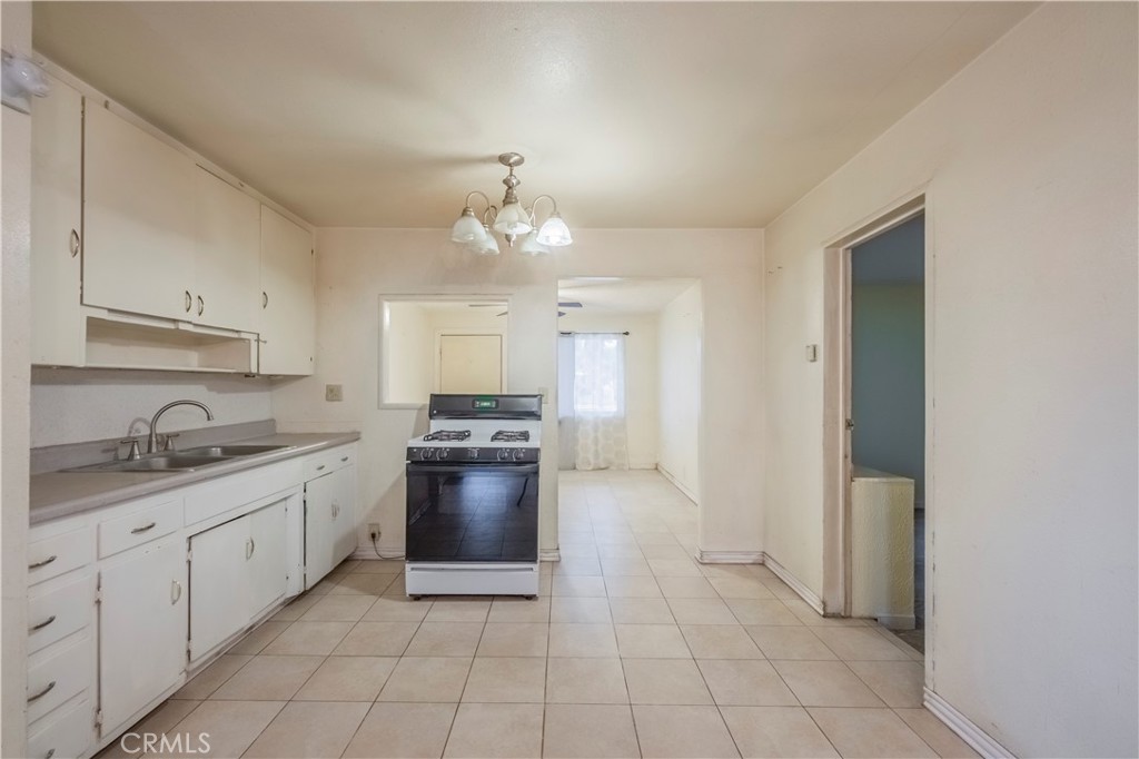 10180 Eddystone Street Riverside, CA 92503 - Photo 21 of 34 a large kitchen with cabinets and stainless steel appliances