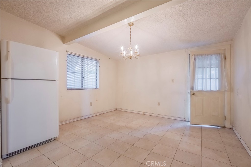 10180 Eddystone Street Riverside, CA 92503 - Photo 23 of 34 an empty room with chandelier fan and windows