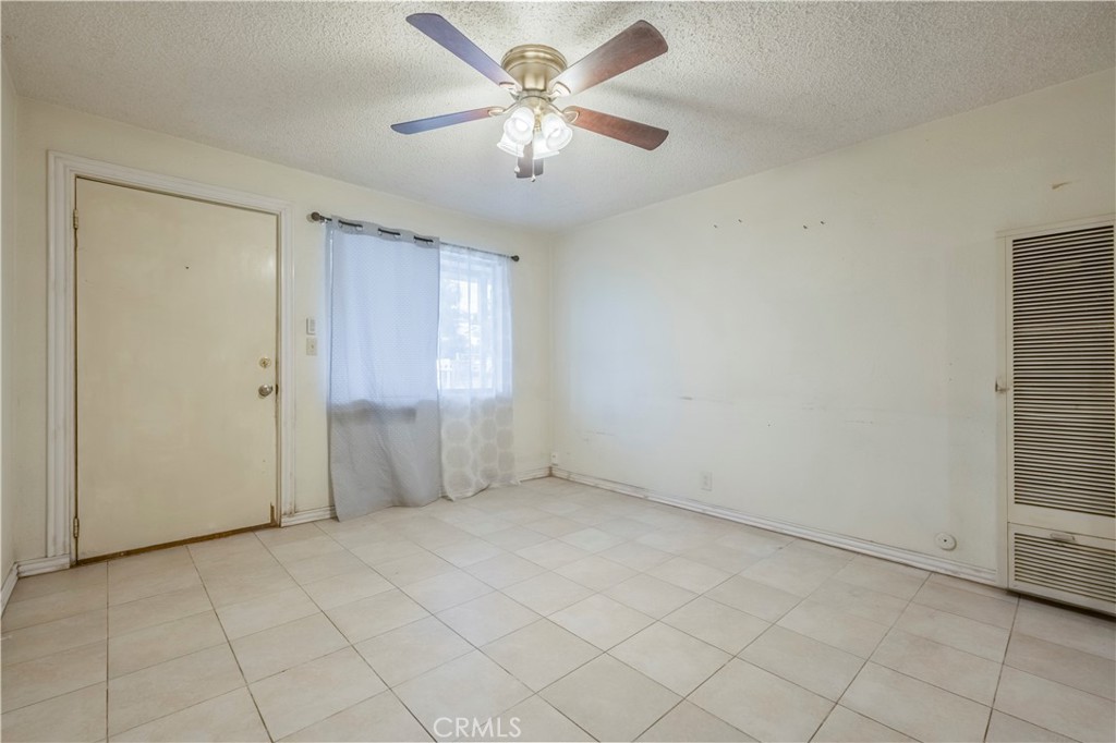 10180 Eddystone Street Riverside, CA 92503 - Photo 24 of 34 an empty room with chandelier fan and windows