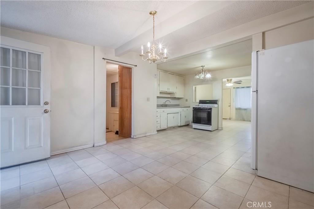 10180 Eddystone Street Riverside, CA 92503 - Photo 26 of 34 a view of a kitchen with an entryway and a chandelier