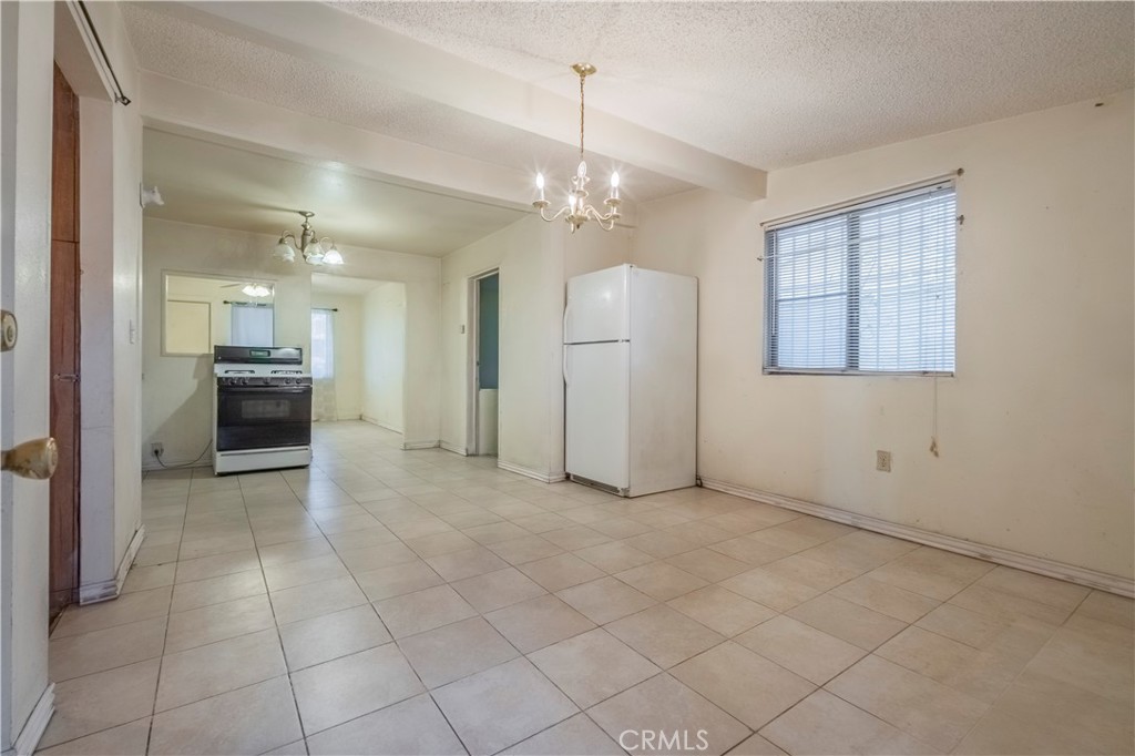 10180 Eddystone Street Riverside, CA 92503 - Photo 29 of 34 an empty room & kitchen view with a ceiling fan