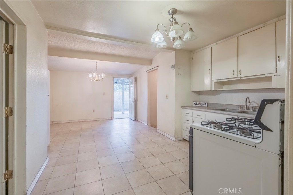 10180 Eddystone Street Riverside, CA 92503 - Photo 30 of 34 a kitchen with stainless steel appliances granite countertop a stove a sink and a refrigerator