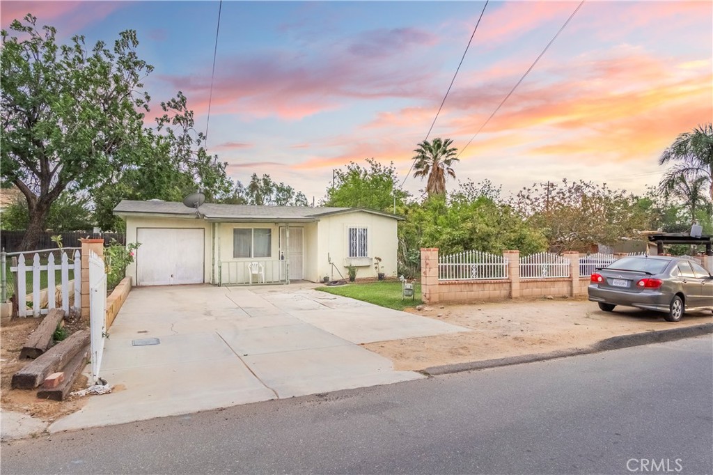10180 Eddystone Street Riverside, CA 92503 - Photo 10 of 34 a view of a house with a yard and garage