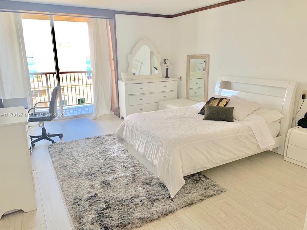 150 Southeast 25th Road, Unit PHA Miami, FL 33129 - Photo 11 of 24 a bedroom with a bed and wooden floor