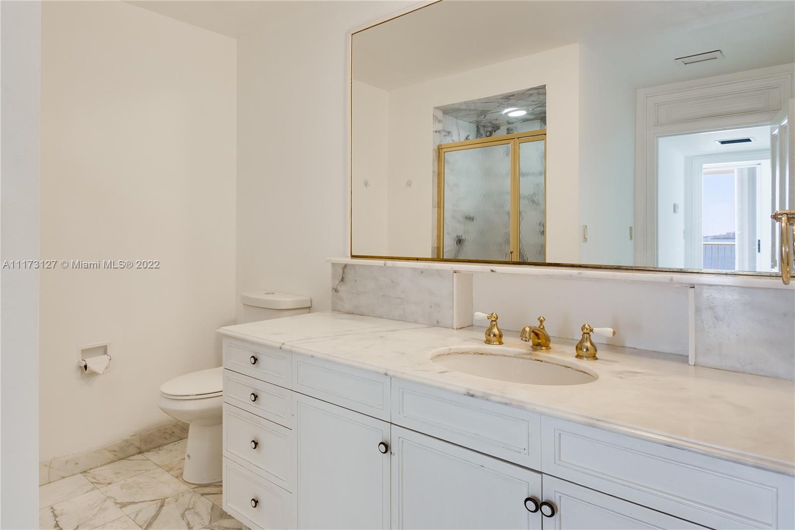 150 Southeast 25th Road, Unit PHA Miami, FL 33129 - Photo 15 of 24 a bathroom with a granite countertop sink mirror vanity and toilet