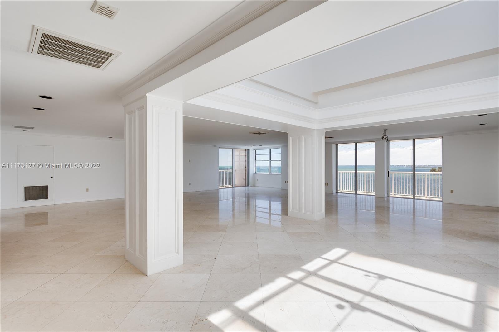 150 Southeast 25th Road, Unit PHA Miami, FL 33129 - Photo 3 of 24 an empty room with floor to ceiling window and glass door