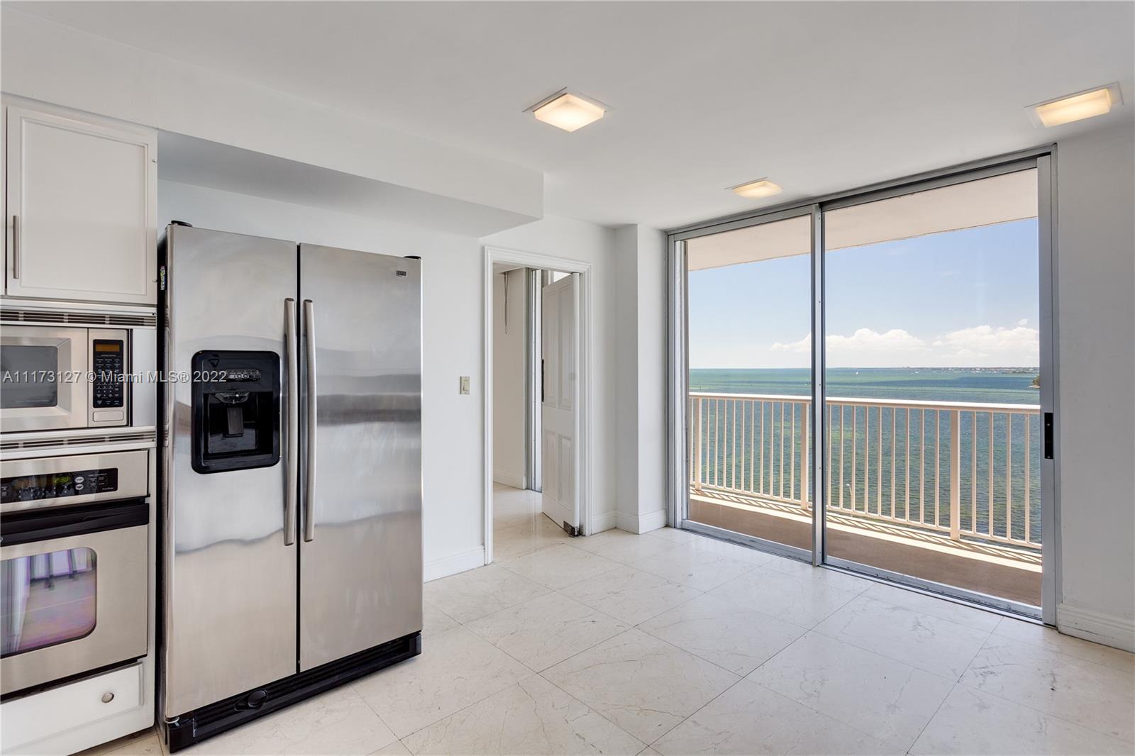 150 Southeast 25th Road, Unit PHA Miami, FL 33129 - Photo 9 of 24 a view of a kitchen with a stove fridge and front door