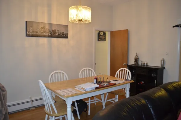 a dining room with furniture a window and wooden floor