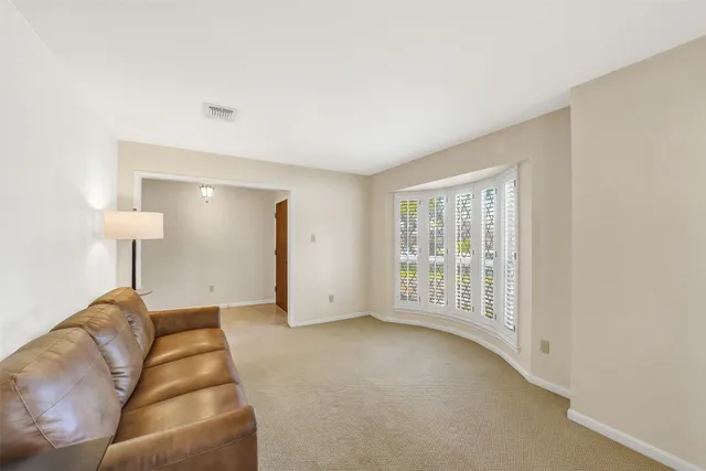 a living room with furniture and a lamp