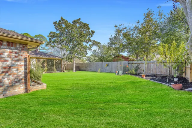 a view of a house with a backyard