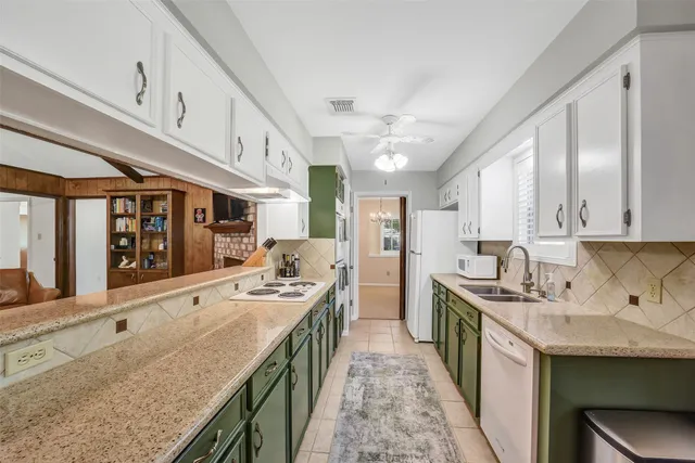 a kitchen with stainless steel appliances granite countertop a sink stove and cabinets