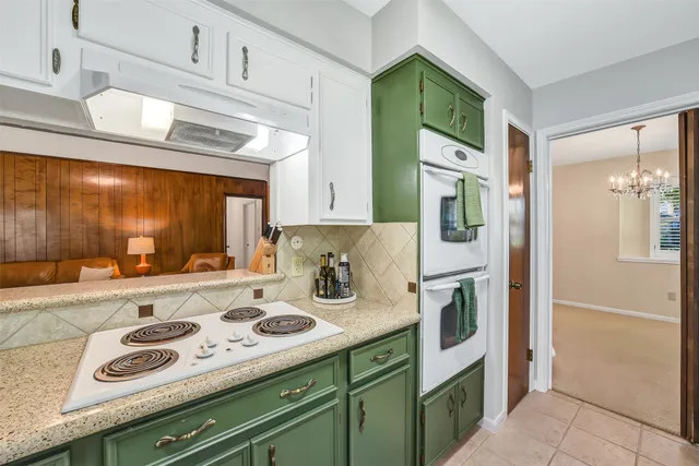 a kitchen with a refrigerator and cabinets