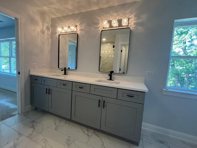 a bathroom with a double vanity sink and a mirror