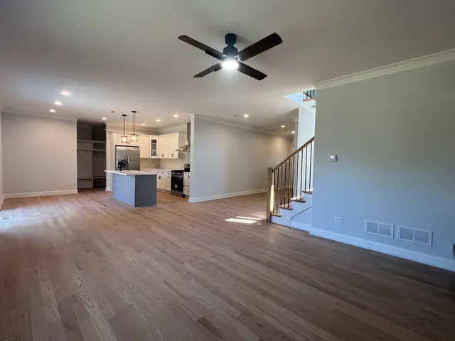 a view of kitchen and hall with wooden floor