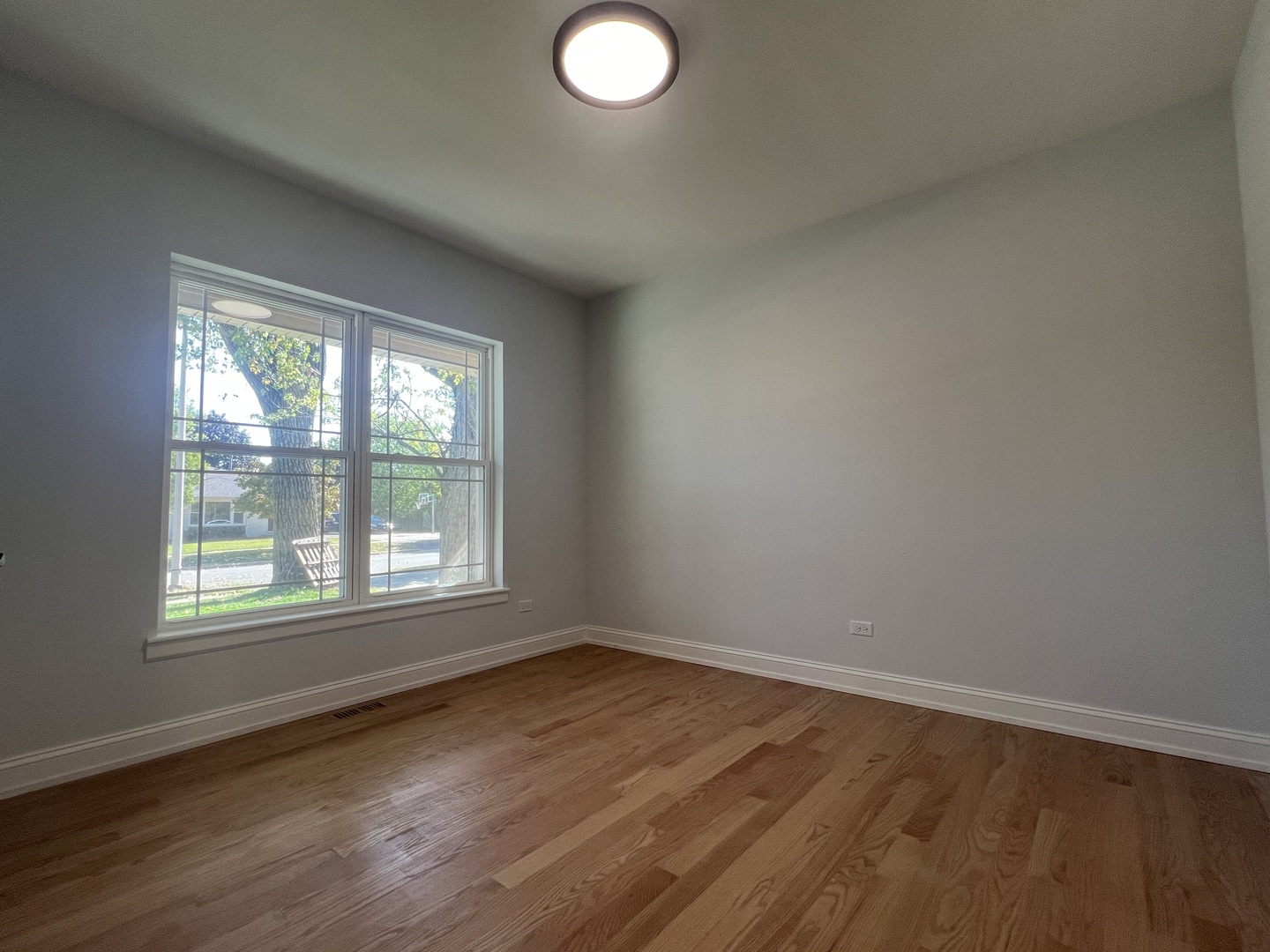 10832 Massasoit Avenue Chicago Ridge, IL 60415 - Photo 7 of 14 an empty room with wooden floor and windows