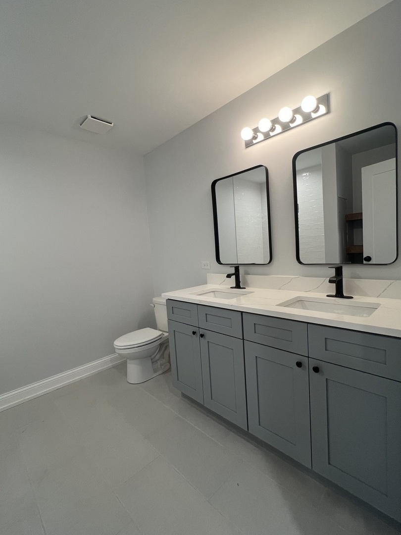 10832 Massasoit Avenue Chicago Ridge, IL 60415 - Photo 10 of 14 a bathroom with a toilet sink and mirror