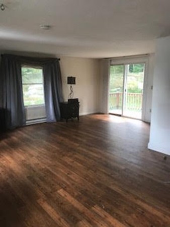 139 Fairview Park Road Sturbridge, MA 01566 - Photo 5 of 15 a view of an empty room with wooden floor and a window