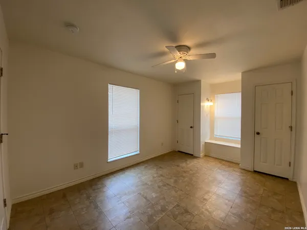 a view of an empty room with a ceiling fan