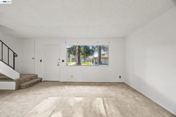 a view of an empty room with stairs