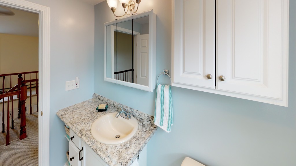20 Chamber Rock Road Bourne, MA 02532 - Photo 21 of 30 a bathroom with a granite countertop sink and a mirror