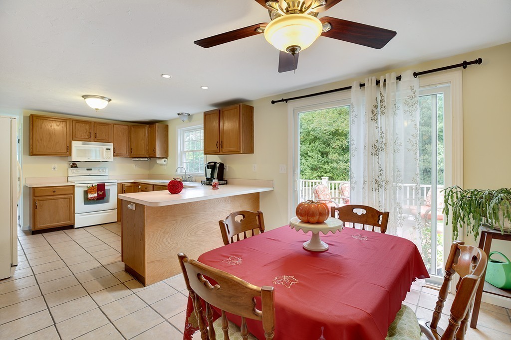 20 Chamber Rock Road Bourne, MA 02532 - Photo 9 of 30 a kitchen with a refrigerator coffee maker on table and chairs