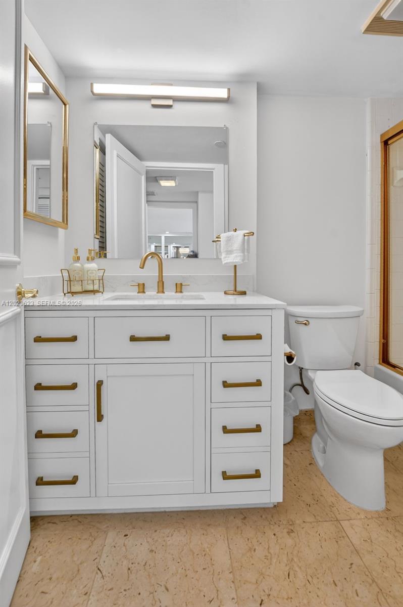 4101 North Ocean Boulevard, Unit 1605 Boca Raton, FL 33431 - Photo 20 of 35 a bathroom with a sink toilet vanity and mirror