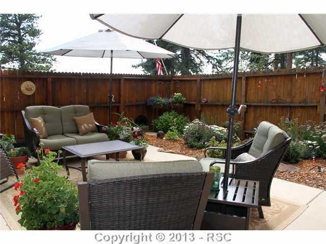 1122 NORTH Rd Divide Divide, CO 80814 - Photo 19 of 25 Quiet patio area with fencing - and wonderful flowers & plants already in!