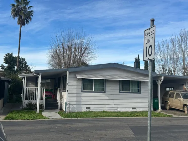 a house that has a tree in front of it