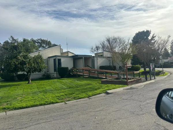 a view of a house with a yard porch and sitting area