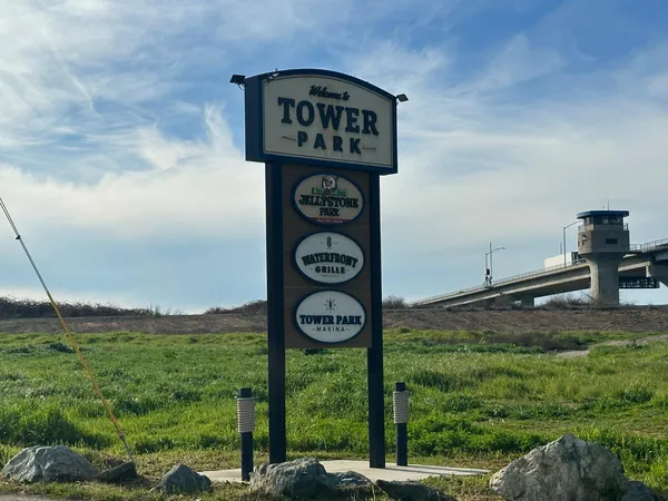 a room with lots of frames on wall and a chandelier